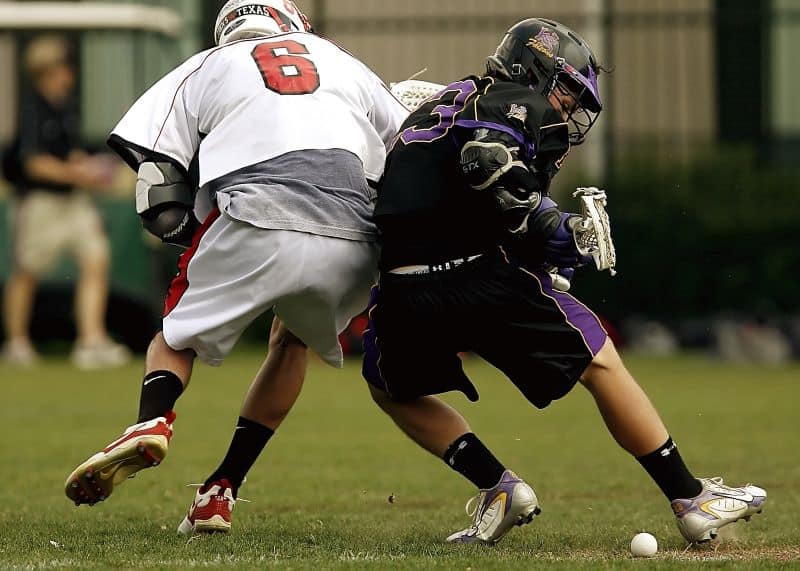 two lacrosse players battle for the ball but What Are Lacrosse Cleats?