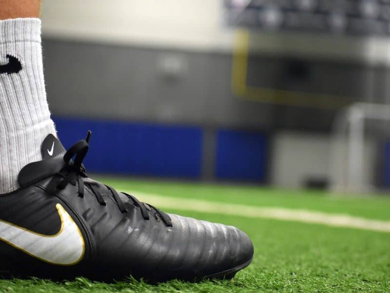 player wears black soccer cleats on the field