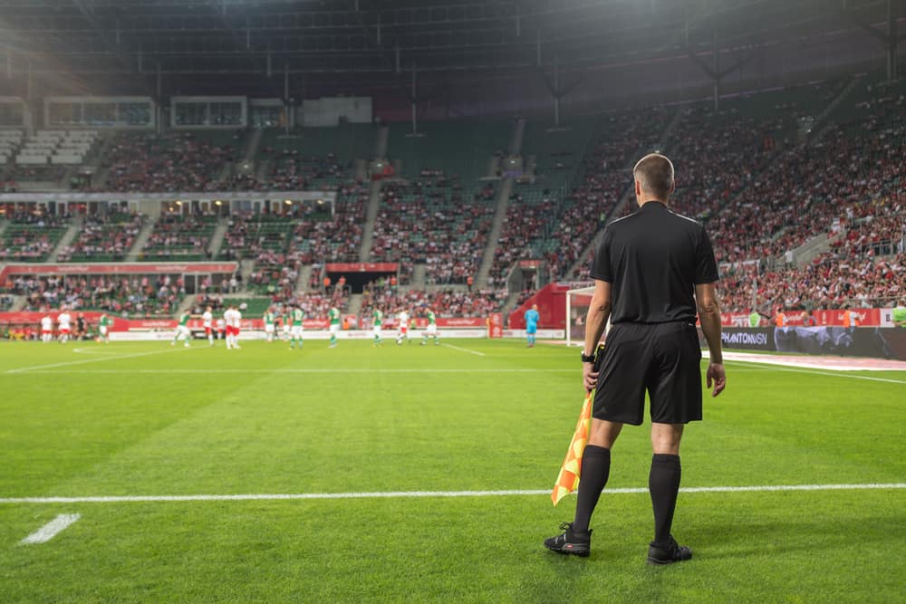 linesman looks on at the dying minutes of a close game